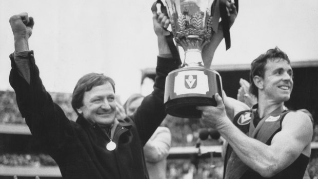 Doubling up: Kevin Sheedy and Terry Daniher lift the 1985 premiership cup.