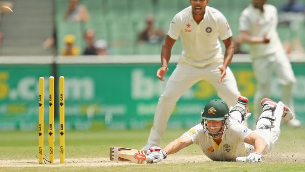 Caught short: Shaun Marsh makes a  desperate lunge for the crease but falls short to miss out on a century by one run.