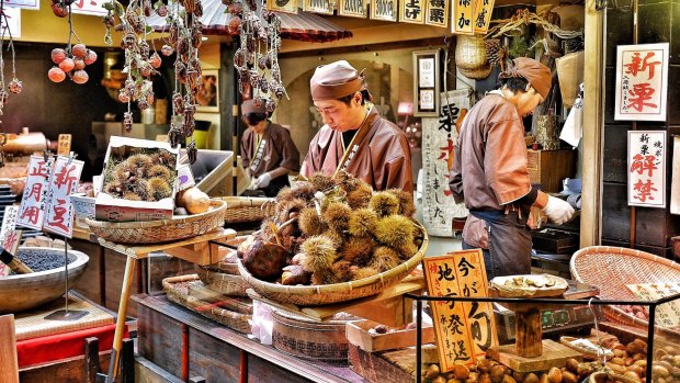 The vendors is preparing the chestnuts for sell at Nishiki Market in Kyoto, Japan. 