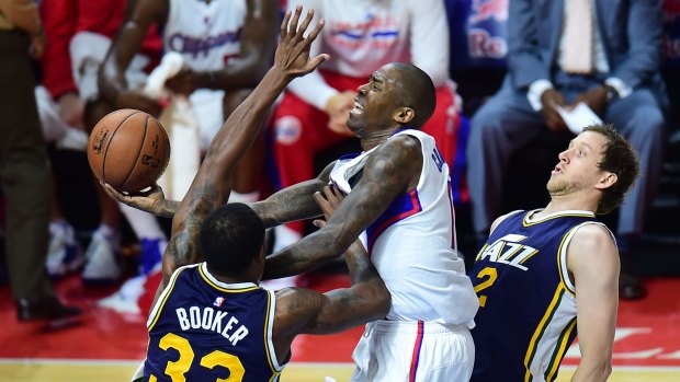Crowded lane: Clippers guard Jamal Crawford tries to get around Trevor Booker and Joe Ingles.