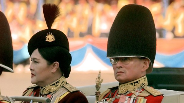 Thai King Bhumibol Adulyade and Queen Sirikit review the honour guard in 1999.