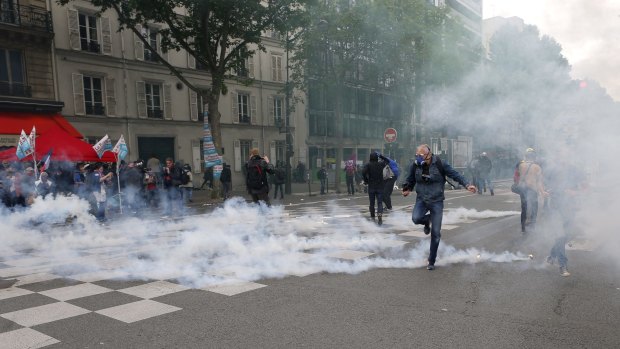A man runs through smoke during a demonstration in Paris on Tuesday.
