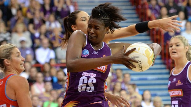Grab for possession: Firebirds shooter Romelda Aiken competes for the ball during the ANZ Championship Grand Final against the NSW Swifts at Brisbane Entertainment Centre.