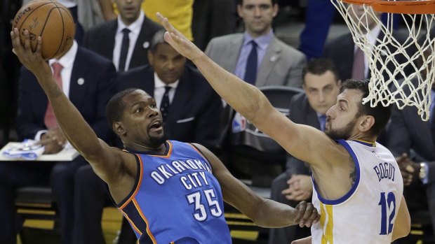 Defensive presence: Oklahoma City Thunder forward Kevin Durant tries to shoot against Golden State Warriors centre Andrew Bogut during Game 5 of the Western Conference finals in Oakland.