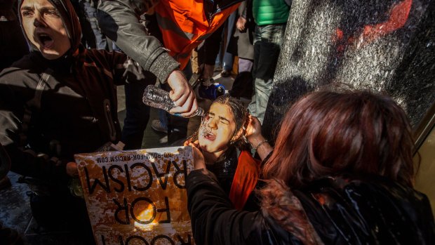 A member of Rally Against Racism after being capsicum sprayed by Victoria Police.