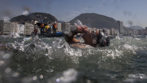 Heidi Gan, of Malaysia, drinks during the women's open water event, also referred to as the marathon swim.