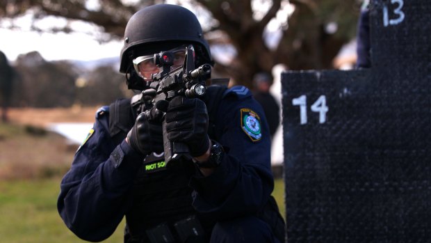 A member of the NSW Public Order and Riot Squad with a newly-issued Colt M4 assault rifle.