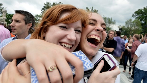 Two women celebrate outside the Supreme Court in Washington, DC.