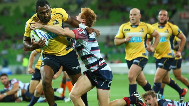  Tevita Kuridrani of the Brumbies breaks through a tackle by Nick Stirzaker of the Rebels to score.