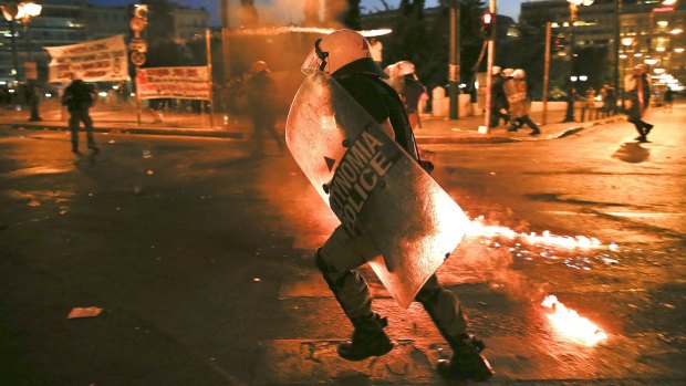 Greek anti-establishment protesters threw  petrol bombs at police in front of parliament on Wednesday.