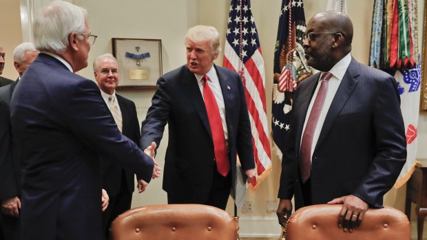 Donald Trump, greets Independence Blue Cross and Health CEO Joseph Swedish, left, and Kaiser Permanente CEO Bernard Tyson, right.