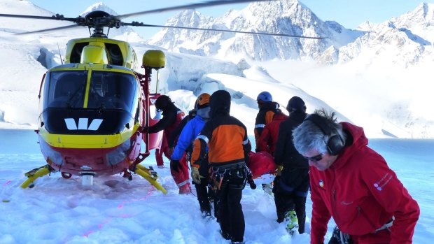 Rescuers and colleagues attend to the body of an Australian soldier killed on Aoraki Mount Cook in New Zealand.