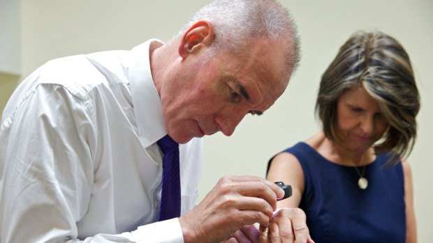 Summer rush: Dr James Barnes from Dee Why Skin Cancer and Cosmetic Clinic examines a patient.