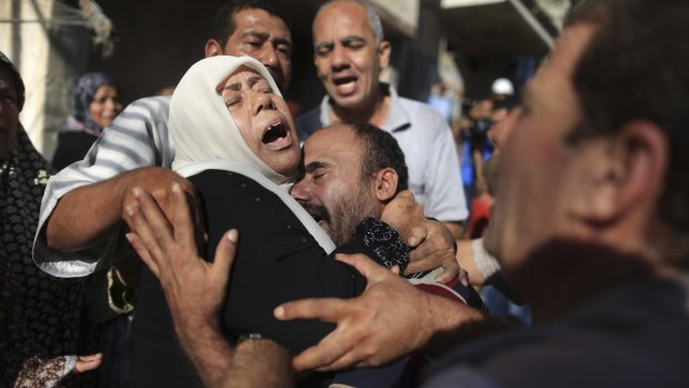 July 2014: Members of the Bakr family mourn during the funeral in Gaza City for four of their children killed on the beach by an Israeli strike.