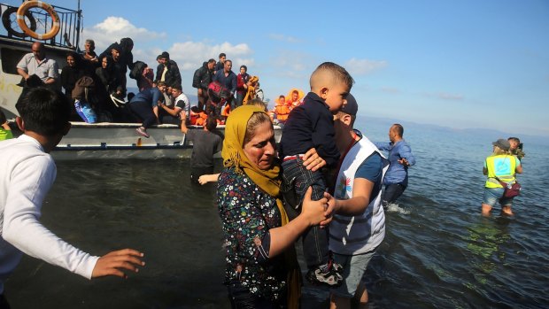 Syrian and Iraqi migrants continue to arrive on boats in Lesbos, Greece, from Turkey .