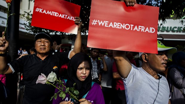 People hold placards and banners displaying the words "we are not afraid" during a rally after the Jakarta terrorist attack  in January.