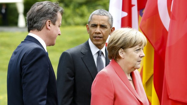 German Chancellor Angela Merkel walks with US President Barack Obama and British Prime Minister David Cameron at the G7 summit.