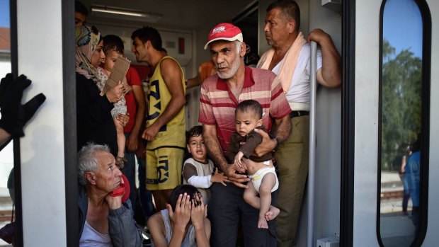 Young and old, refugees board trains at the station in Beli Manastir on Friday.