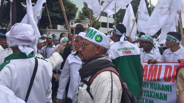 Demonstrators rally in Jakarta on Friday to demand the arrest of the city's governor.