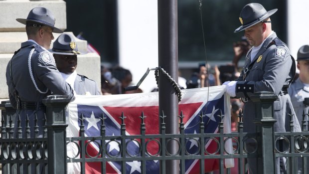 Symbol of hate ... The Confederate battle flag is removed from the Capitol grounds in Columbia, South Carolina.