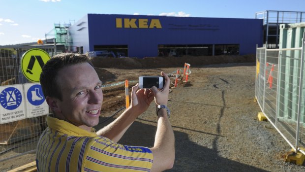 Canberra store manager Mark Mitchinson takes a photo of the familiar IKEA letters at the site at Majura Park.