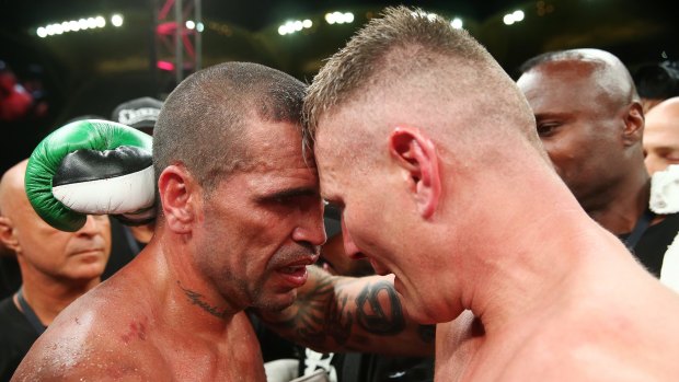 Mundine and Green hug at the end of their bout.