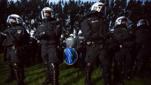 Riot police surround anti-G20 protesters and the sleeping tents they had erected at a camp at in Hamburg, Germany, on Sunday.