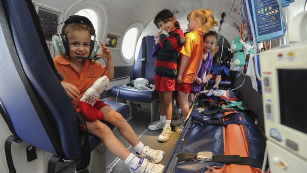 The Royal Flying Doctor Service simulator aircraft touched down at the Canberra Girls Grammar Junior School in Deakin. Prep students got the chance to explore the cockpit and the patient treatment area. Five-year-old Lucia Capezio, left, tries on some headphones.
