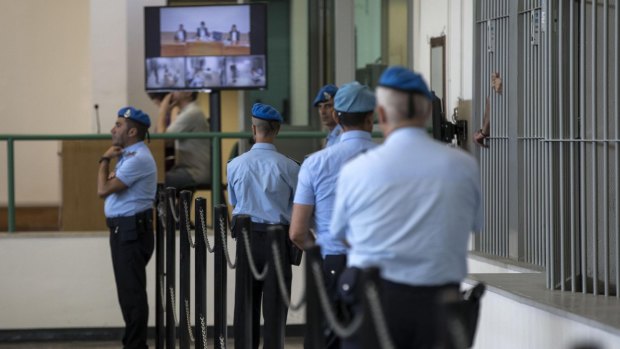Italian Penitentiary police officers stand inside the court hall during the corruption trial in Rome on Thursday.