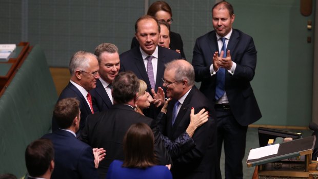 Treasurer Scott Morrison is congratulated by Minister Julie Bishop after he gave the Budget address at Parliament House in Canberra.