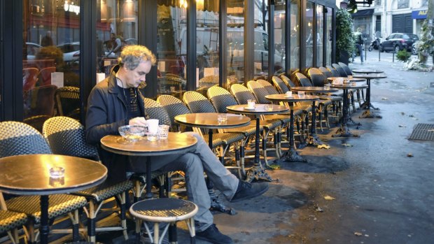 A man takes a seat at A la Bonne Biere cafe in Paris during its reopening on Friday, for the first time since the attacks of November 13, in which five people were killed on its premises.
