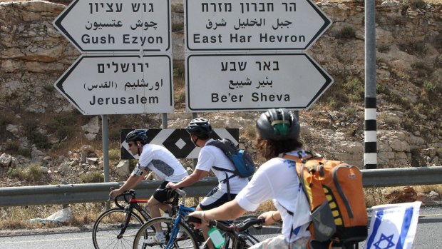 Israeli settlers take part in a bicycle ride from the Israeli settlement of Kiryat Arba, in the occupied West Bank, to Jerusalem on Monday to support a 'Jewish Jerusalem'. 