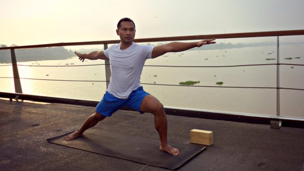 Alex Salihin leading a yoga class on Aqua Mekong.