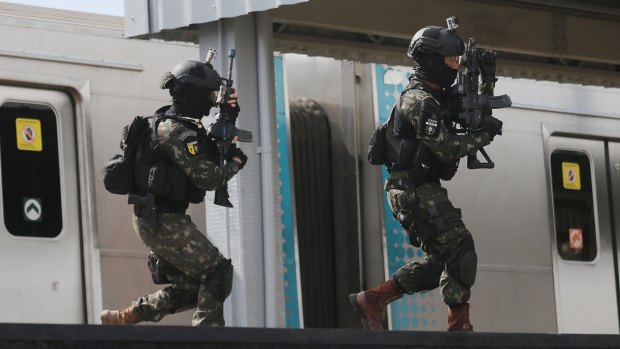 Brazilian soldiers conduct a counter-terrorism drill simulating an attack at the Deodoro train station in Rio last week.