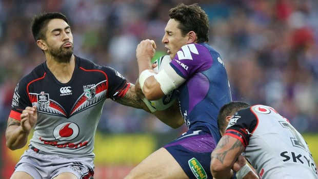 Crunch time: Storm veteran Billy Slater is tackled up top by Warriors halfback Shaun Johnson.