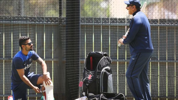 Virat Kohli talks to India's director of cricket Ravi Shastri in the nets at the Adelaide Oval on Monday.