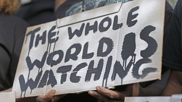 A man holds a sign during a protest for the shooting death of Walter Scott in South Carolina on Wednesday. 