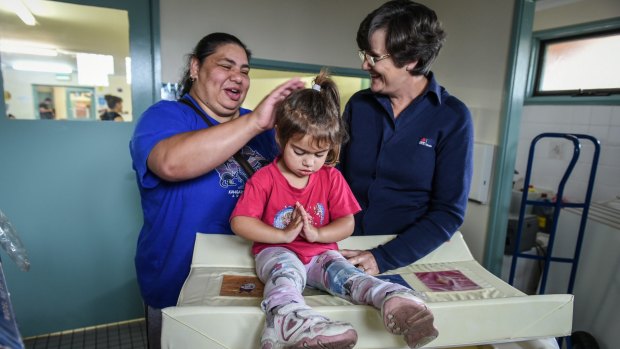 Vicky Parisi and her daughter Liana Johnson, 3, with registered nurse immuniser Mary Anne Crane at the 
Koolyangarra centre in Cranebrook.