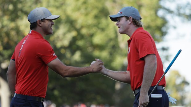 Whitewash: Brandt Snedeker and Brooks Koepka celebrate a birdie on the eighth hole for the US team.