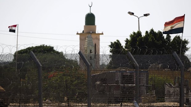 Egyptian flags flutter in Egypt's North Sinai as seen from across the border in southern Israel.