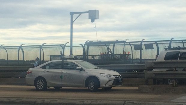 The man got out of this taxi before climbing up the Sydney Harbour Bridge.