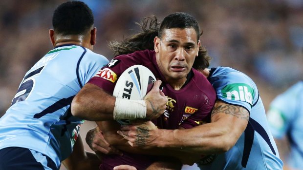 Public enemy: Justin Hodges of the Maroons is tackled during Origin I.