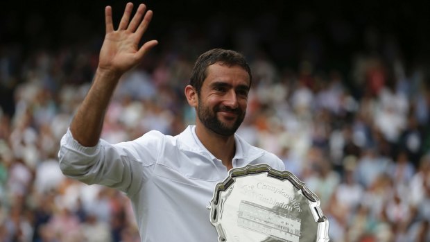 The smile returns: Marin Cilic holds the runners-up trophy.