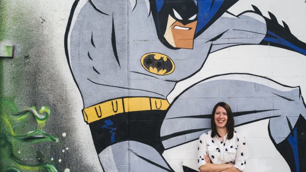 The ACT's new graffiti co-ordinator Louise Emberson with legal street art in Tocumwal Lane off Garema Place.
