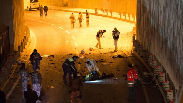 Forensic policemen and officers attend the scene following a twin bomb attack  in Istanbul.