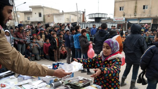 A photo from an Islamic State propaganda website shows distribution of sweets, soft drinks, and religious texts in Tel Abyad, north-east Syria.  