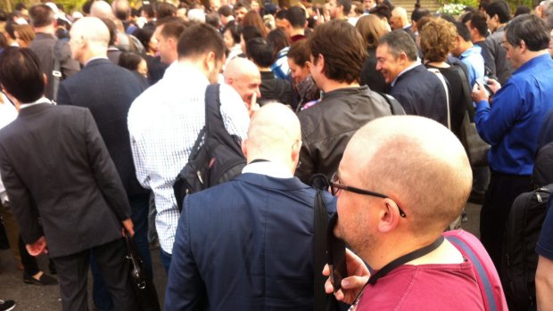 Attendees and the media queue to get into the packed Apple event.