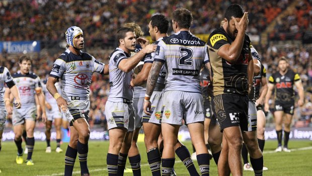Tight tussle:  Cowboys players celebrate a try during their 23-18 win over the Panthers.