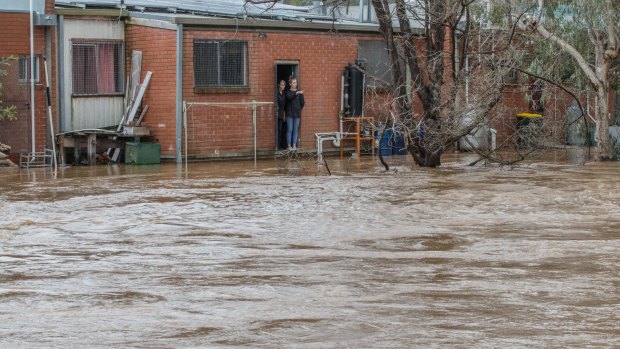 Residents of Myrtleford watch the rising floodwaters.