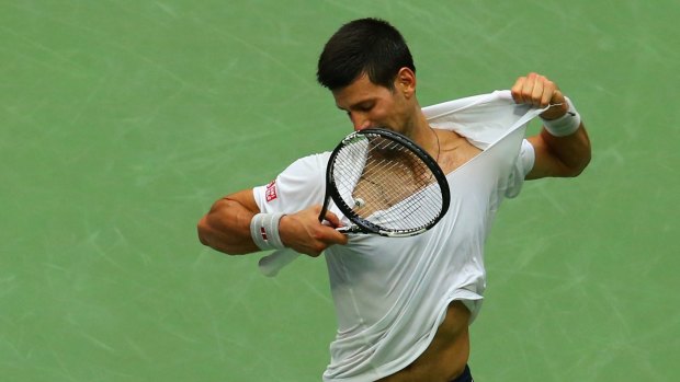 Rage: Djokovic tears off his shirt in anger after losing the third set to Monfils.